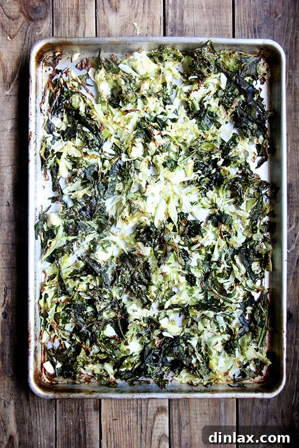 Mediterranean Freekeh Salad with Roasted Kale and Cabbage 4 Roasted cabbage and kale on a baking sheet, showcasing the beautiful caramelization and crispy texture achieved after oven roasting, ready to be added to the Freekeh Salad.