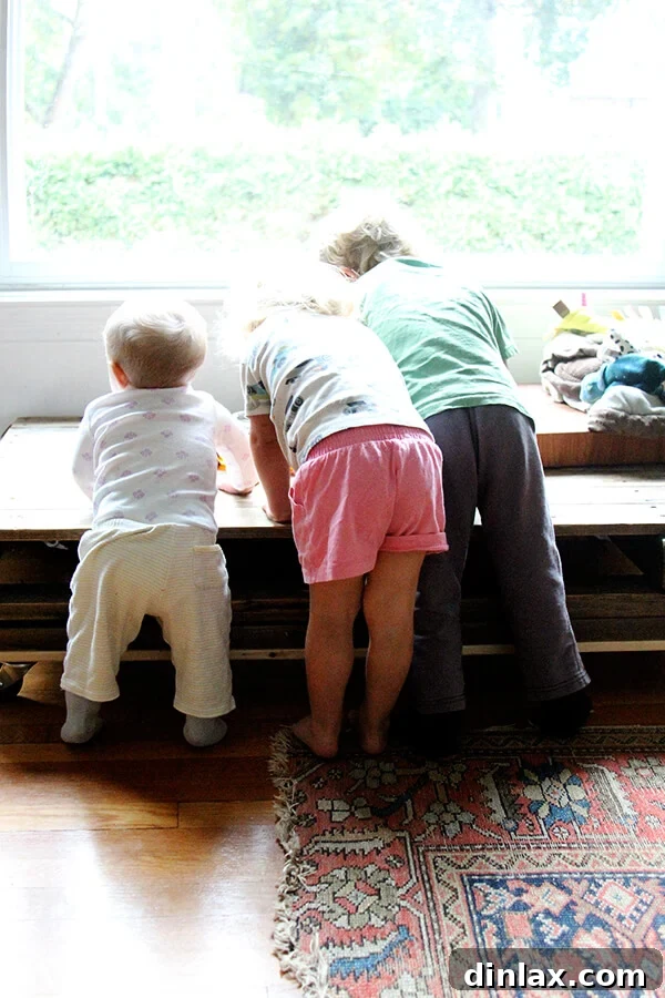 Enthusiastic children happily helping to clean up the kitchen, demonstrating teamwork after preparing the crispy treats.
