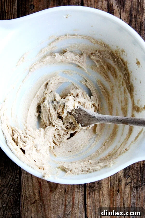 Creaming softened butter and light brown sugar together in a bowl until light and fluffy.