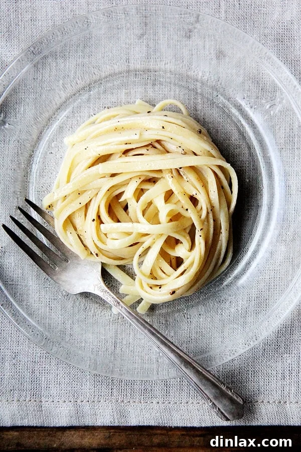 Close-up of the delectable Cacio e Pepe pasta, showcasing its exquisite texture and visual appeal. Cacio e pepe, a classic Italian dish, relies on starchy pasta cooking water to form a creamy emulsion with butter and cheese, often Parmigiano Reggiano and Pecorino Romano, and it couldn't be more delicious or simple. I like simple. // alexandracooks.com