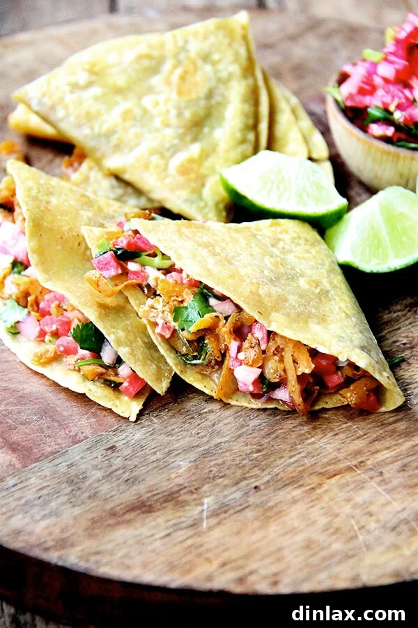 Delicious sweet potato quesadillas served on a rustic wooden board, garnished with fresh cilantro and a side of vibrant salsa.