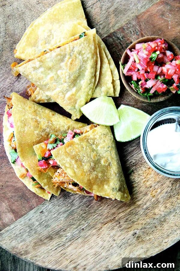 A beautiful presentation of sweet potato quesadillas, freshly cooked and cut into wedges, arranged on a wooden board.