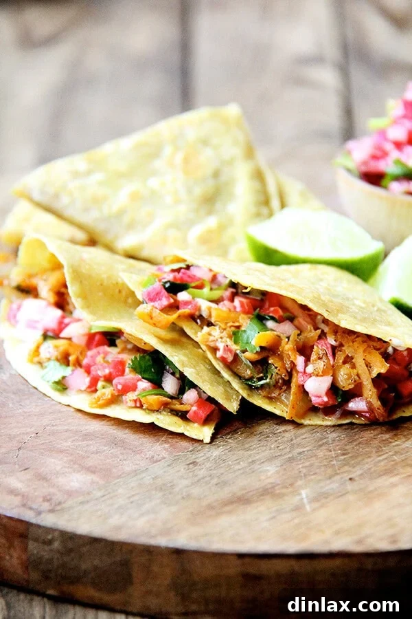 Sweet potato tacos or mini quesadillas arranged on a wooden serving board, showcasing their vibrant colors and appealing presentation.