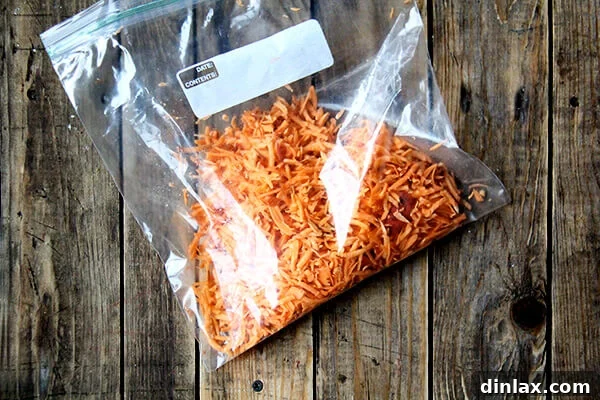 Freshly grated sweet potato stored in a clear ziplock bag, ready for refrigeration.