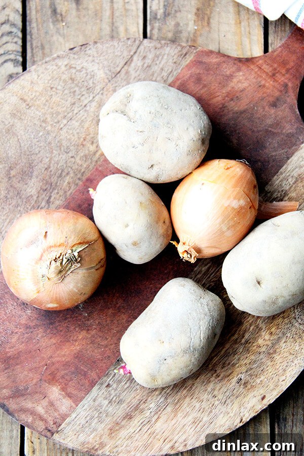 MFK Fisher's Comforting Potato Soup 2 Sliced onions and peeled potatoes, ready for sautéing as the first step in making the creamy potato soup.