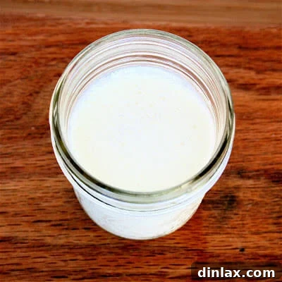 Creamy Buttermilk Panna Cotta in a glass dish, garnished with fresh berries.