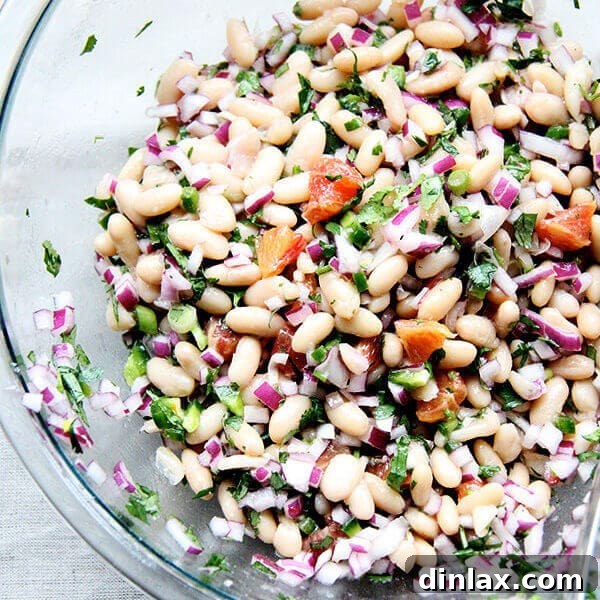 White Bean and Orange Salsa served in a bowl with chips.