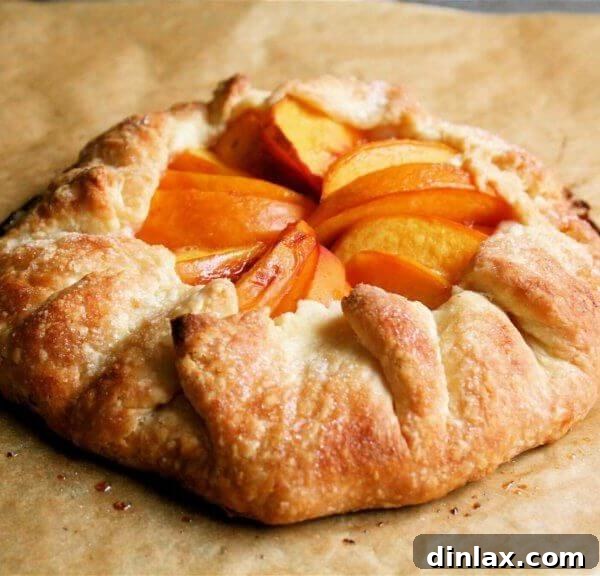 A freshly baked peach tart, golden and glistening, cooling on a wire rack.