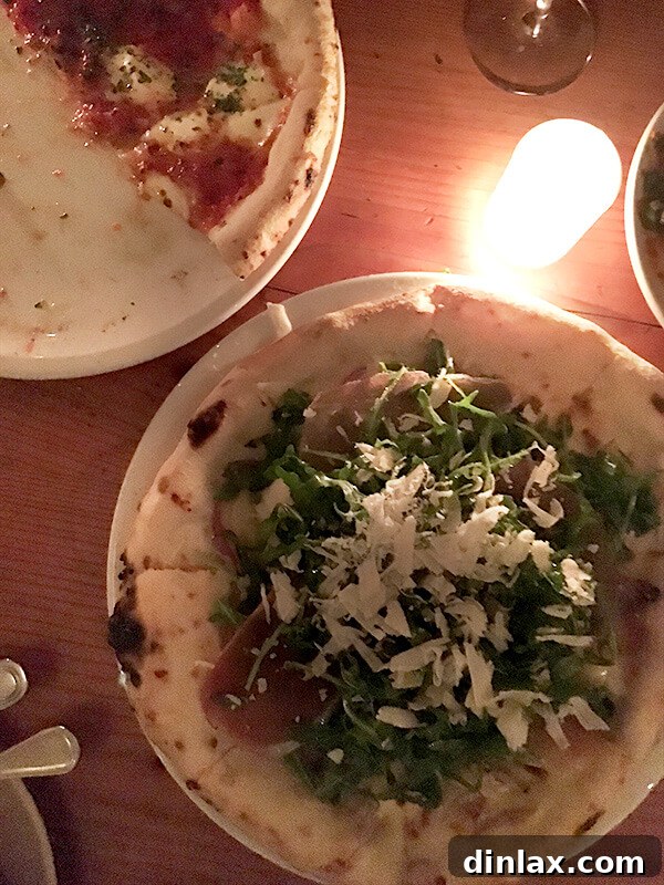 Cookbook Shoot Secrets and Bay Area Food Finds 17 A fresh arugula pizza, topped with vibrant green leaves, served on a wooden board at Pizzaiolo.