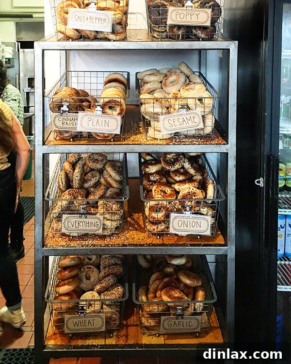 Cookbook Shoot Secrets and Bay Area Food Finds 28 A freshly baked bagel with cream cheese, served on a wooden board with a knife, at Beauty's Bagels.