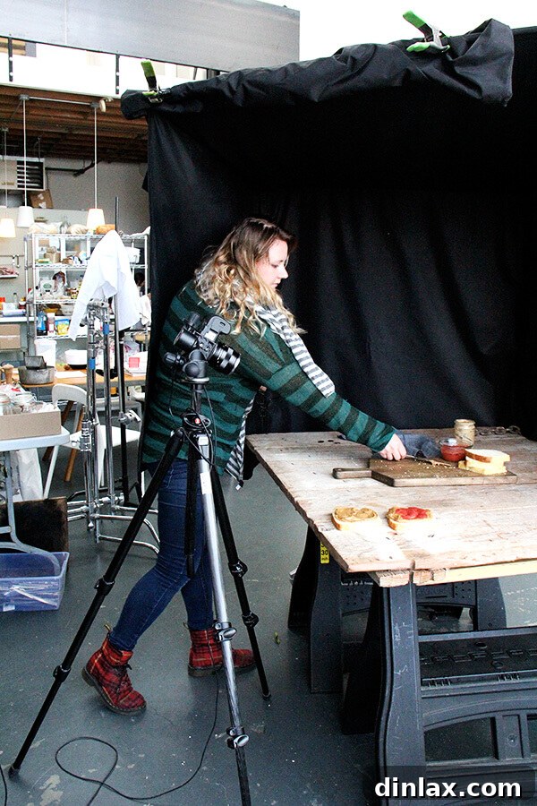 Cookbook Shoot Secrets and Bay Area Food Finds 7 Photographer Eva Kolenko professionally capturing food shots with her camera and lighting equipment in a studio setting.