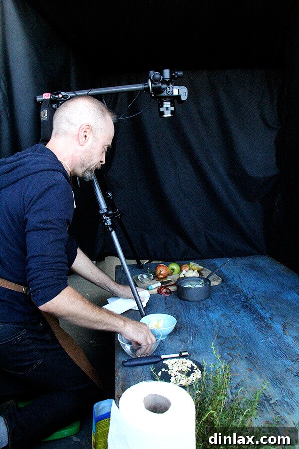 Cookbook Shoot Secrets and Bay Area Food Finds 8 Food stylist Jeffrey Larsen carefully arranging food on a plate, using tweezers and brushes to perfect the presentation for a photo shoot.