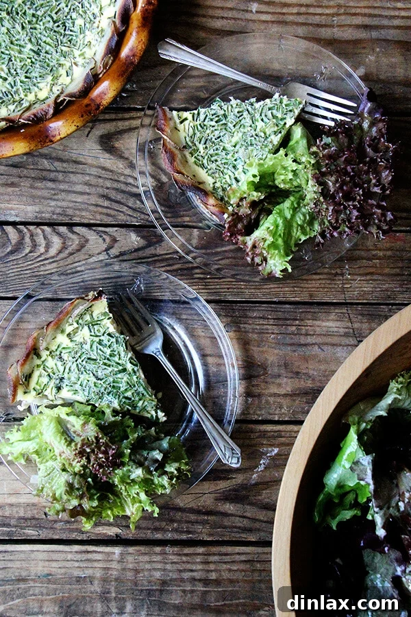 A serving of potato-crusted quiche with a fresh green salad, perfect for a light dinner.
