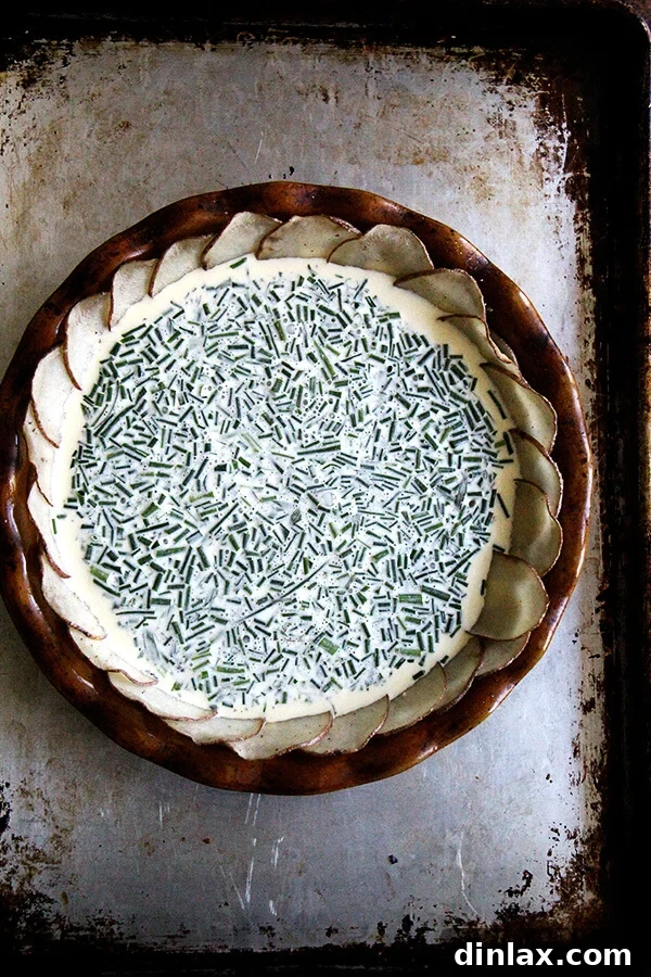 Fresh herbs being added to the prepared quiche custard before pouring into the potato crust.