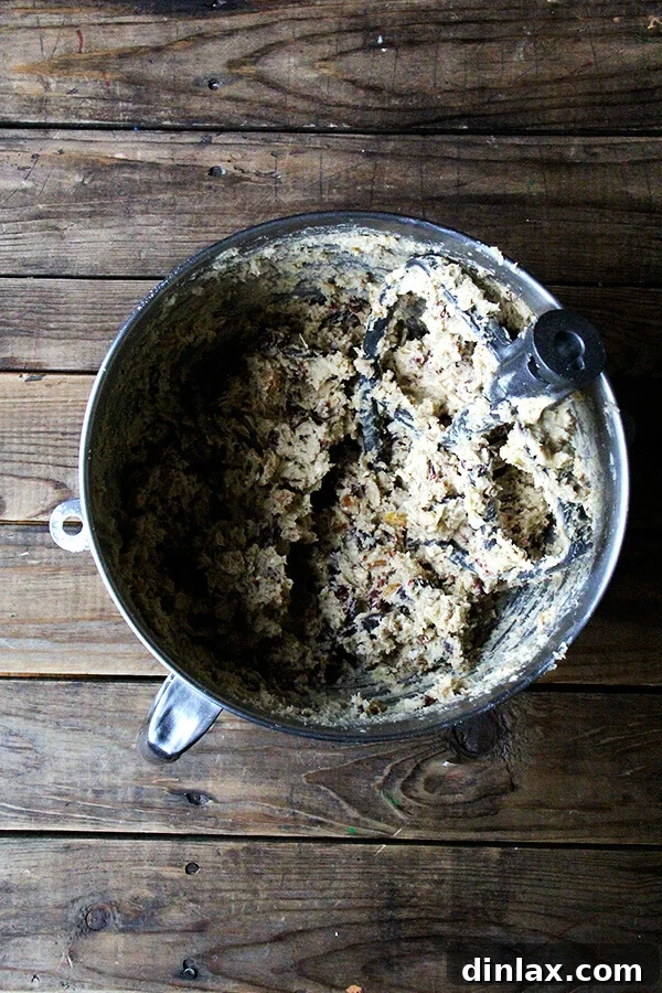 A close-up of Martha Stewart's Giant Kitchen Sink cookie dough, showcasing the rich, buttery texture and generous mix-ins before baking. This batter is a testament to the cookie's promise of abundant flavor.