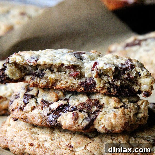 A perfectly baked, colossal Martha Stewart Giant Kitchen Sink Cookie, generously studded with a vibrant mix of chocolate, nuts, and dried fruits, ready to be devoured.