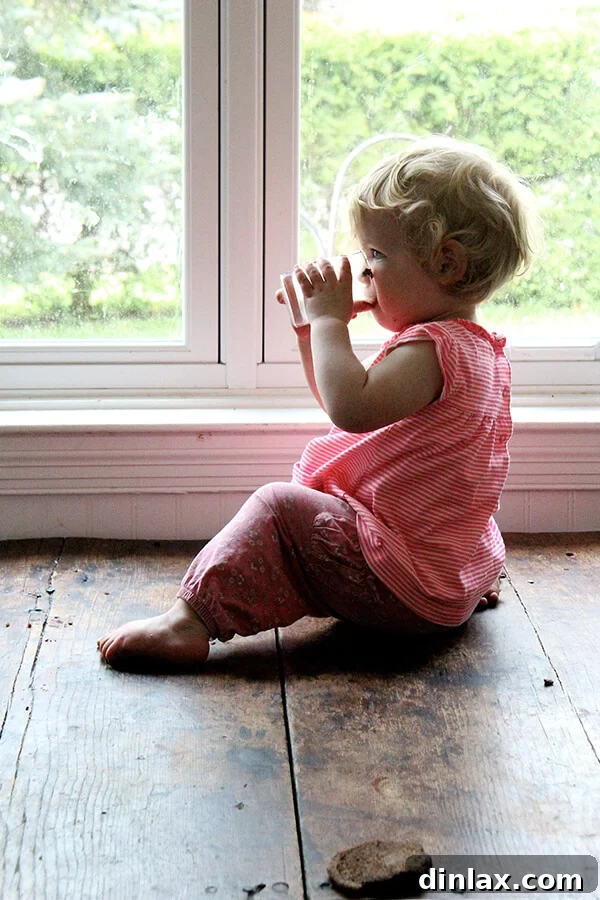 Another young child, Tig, happily eating a double chocolate espresso cookie, showing crumbs on their face.