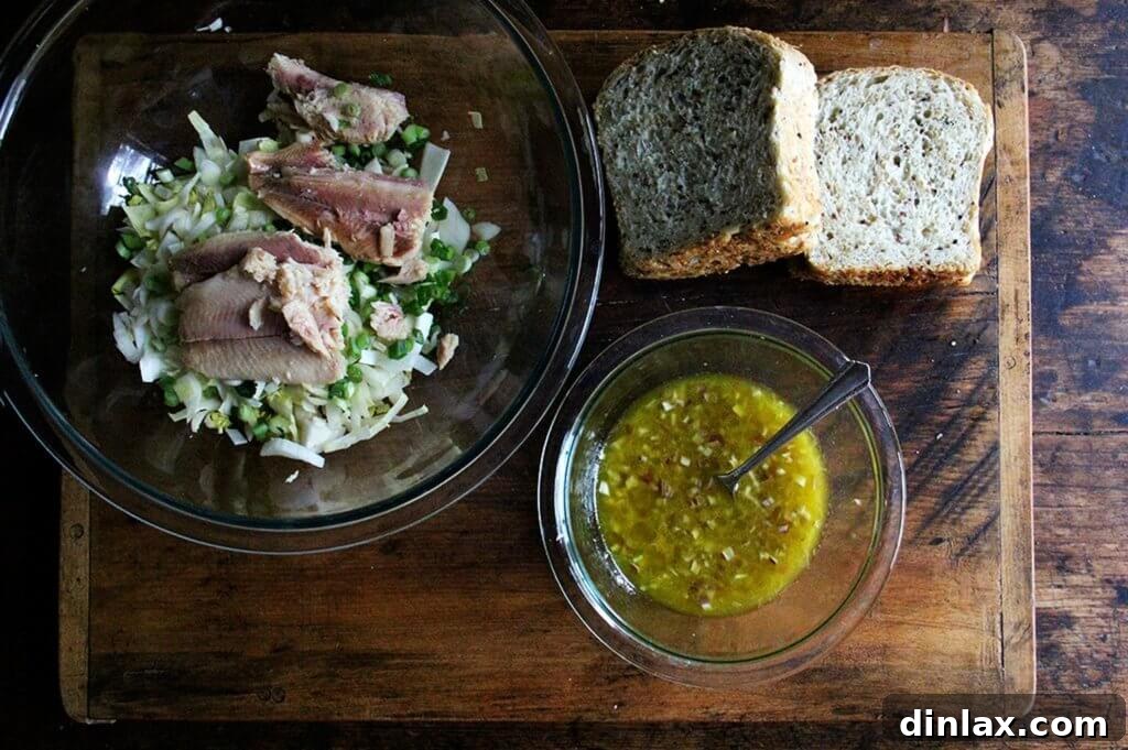 Creamy Avocado Smoked Trout Toasts 5 A close-up of the initial salad components: thinly sliced endive and scallions in a bowl, awaiting the smoked trout.