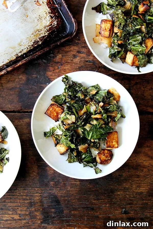 A vibrant bowl of crispy baked tofu, perfectly roasted kale, and golden toasted coconut, served over fluffy coconut rice. This delicious plant-based meal features a four-ingredient sesame-soy dressing.