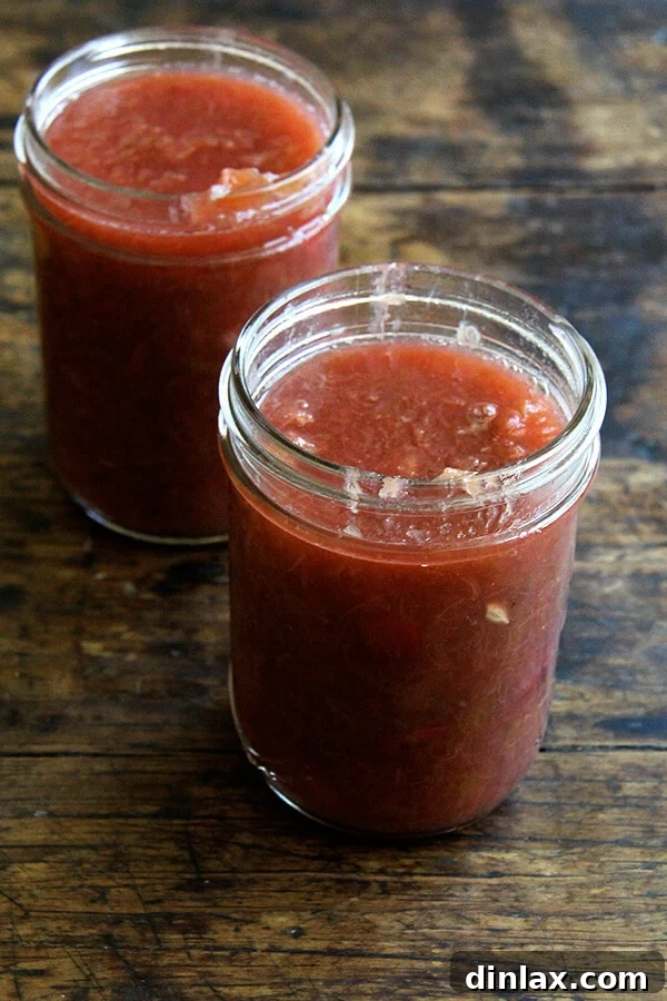 A close-up view of jarred rhubarb compote, showcasing its rich color and inviting texture.