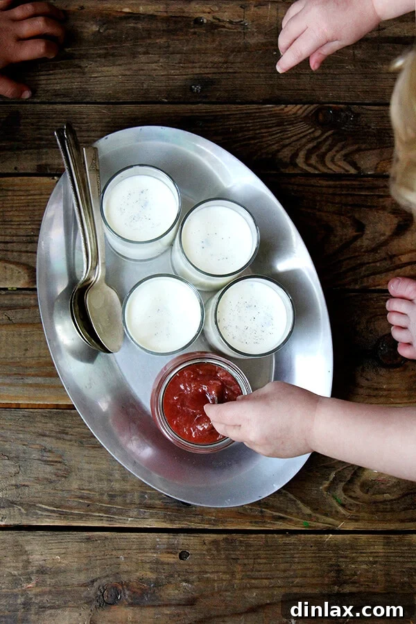 Overhead shot of panna cotta desserts, with children's hands eagerly reaching in, illustrating its universal appeal.