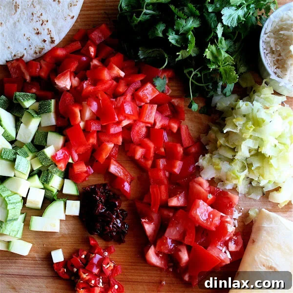 Reinvent Leftover Tortillas Quiche Perfection 3 Variety of chopped vegetables including bell peppers, zucchini, tomatoes, and leeks, ready for quiche preparation.