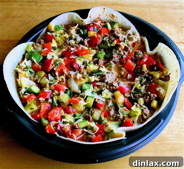 Reinvent Leftover Tortillas Quiche Perfection 5 An unbaked quiche mixture, with colorful vegetables and cheese, poured into the tortilla-lined pan before baking.