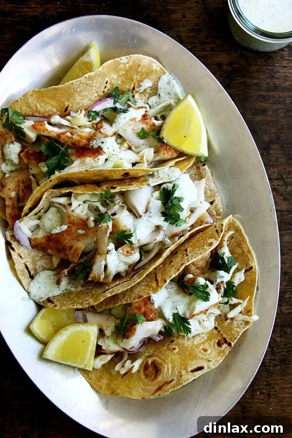 Crispy, skillet-grilled fish nestled in warm tortillas, ready for a fresh topping of slaw and zesty crema. This method ensures perfectly cooked fish every time, making summery fish tacos a breeze.