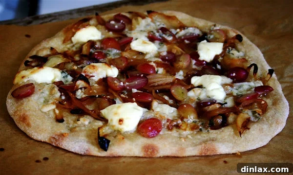 Close-up view of a homemade thin-crust pizza, showcasing minimal toppings and a perfectly golden crust.