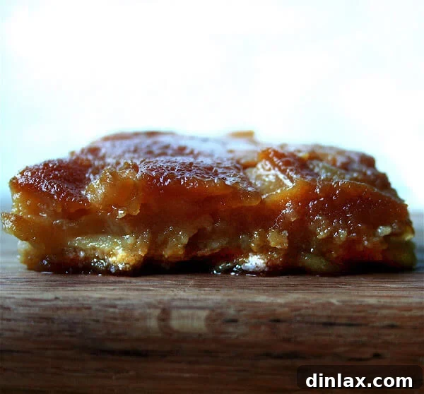A stunning close-up of Gateau Tiede Aux Poires Mas De Cure Bourse, showcasing its golden caramelized pears and custardy base, ready to be enjoyed.