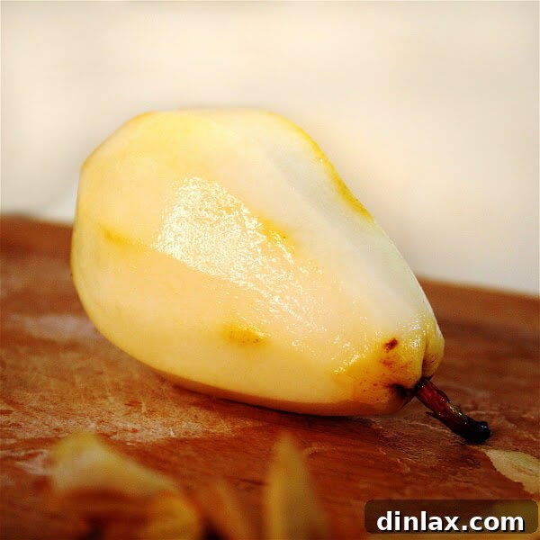 Close-up of golden brown caramelized sugar simmering in a skillet, the first step in creating the rich base for the pear gateau.