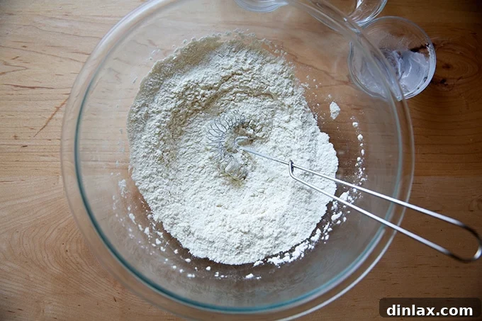The dry ingredients for the orange and olive oil cake are perfectly whisked together in a bowl.