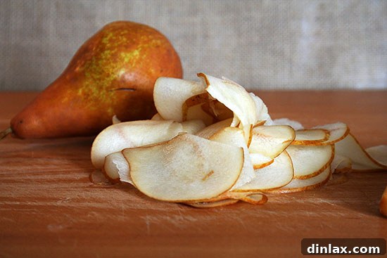 Close-up of thinly sliced ripe pears, highlighting their natural sugars and delicate texture.