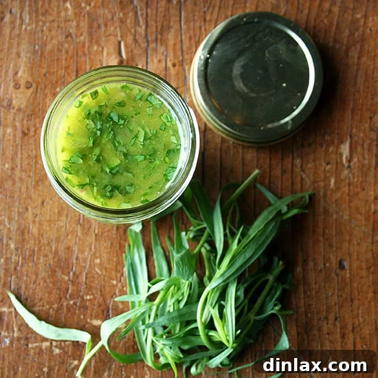 A small bowl of freshly made tarragon-shallot vinaigrette, ready to dress a salad.