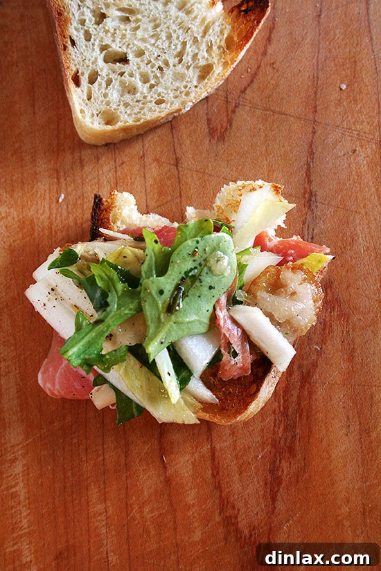 A stunning close-up of the Prosciutto, Pear & Endive Salad, showcasing its fresh ingredients, shaved Manchego, and crisp texture. Perfect for a healthy, gourmet meal. // alexandracooks.com