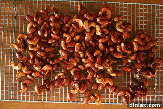Close-up of glistening candied cashews and almonds, ready to be added to granola