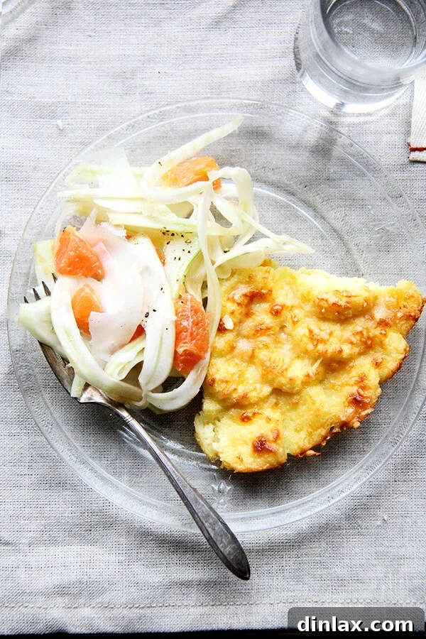 Made with milk, semolina flour, parmesan and egg yolks, this baked semolina gnocchi bears little resemblance to potato gnocchi. They taste more like polenta in fact, but are lighter in texture. In addition to being incredibly delicious, the beauty of gnocchi alla Romana is that it can be completely assembled ahead of time — up to two days — and baked just before serving. // alexandracooks.com A final, mouth-watering view of the finished baked semolina gnocchi, golden and inviting, ready to be enjoyed.