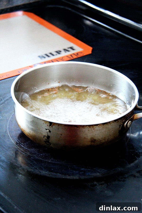 Roman Semolina Gnocchi Bake 12 Frying the semolina fritters in hot oil, achieving a golden, crispy exterior.