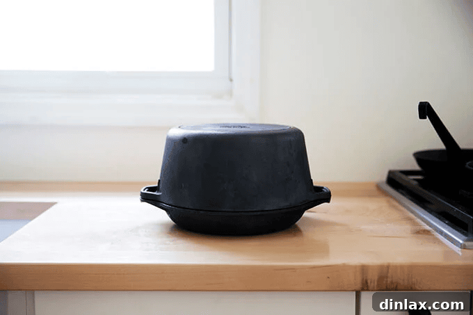 An empty Dutch oven preheating inside a hot oven, ready to create the perfect baking environment for no-knead bread.