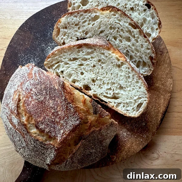 A delicious loaf of Jim Lahey's no-knead bread, beautifully sliced and ready to serve.
