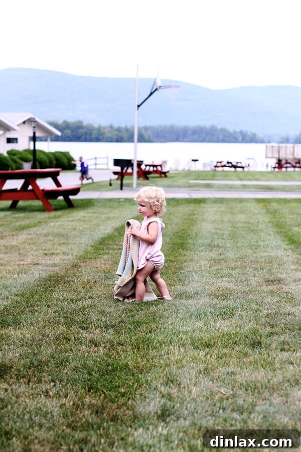 The Queen of American Lakes 4 Baby Tig sitting happily on a colorful blanket near the beach, soaking in the outdoor scenery and enjoying her lakeside vacation.