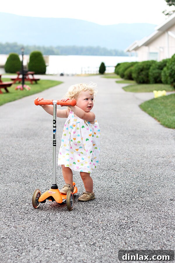 The Queen of American Lakes 6 Baby Tig bravely attempting to ride a scooter on the resort's racetrack, showcasing her adventurous spirit and determination.