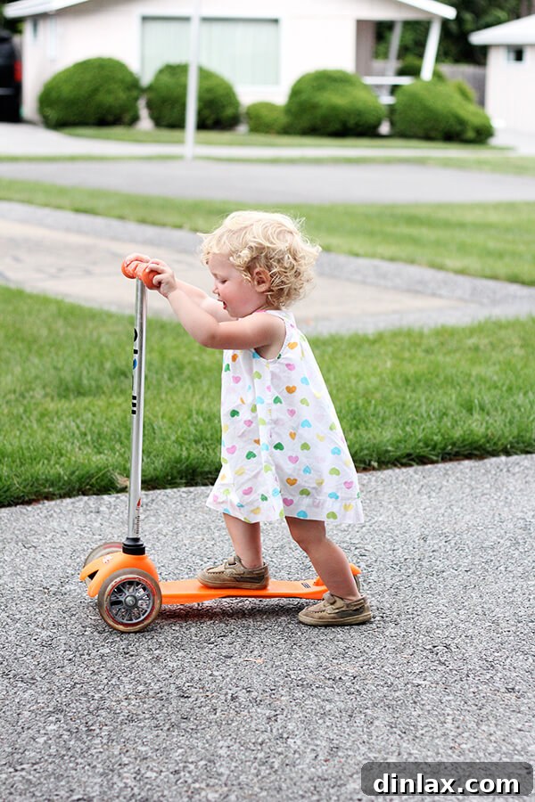 The Queen of American Lakes 7 Tig confidently scootering along the resort path, capturing a moment of pure joy and newfound independence.