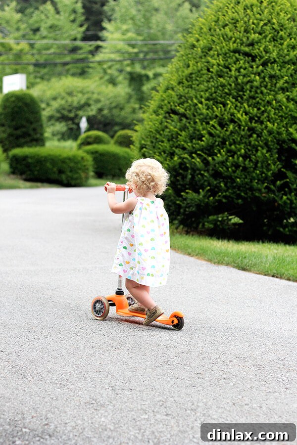 Tig's scooter adventure Tig on her scooter, looking determined and happy as she rides around the resort grounds, enjoying the freedom of movement.