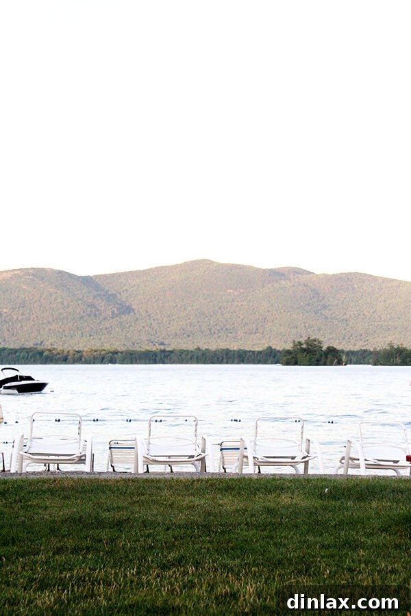 The tranquil beauty of Lake George Another stunning panoramic view of Lake George, highlighting its vastness and the tranquil reflection of the sky on its clear surface.