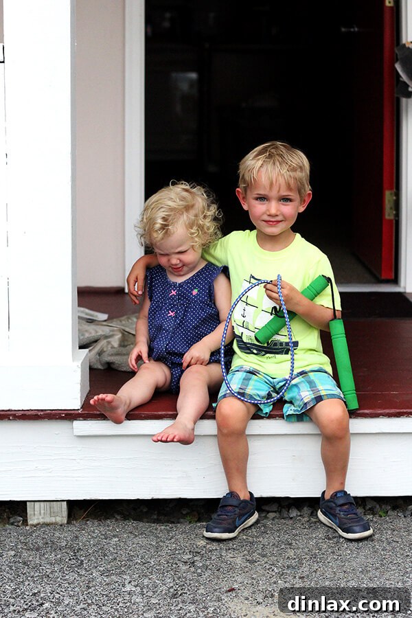 Graham and Tig sharing a meal Graham and Tig enjoying a meal together, siblings bonding over food and laughter.
