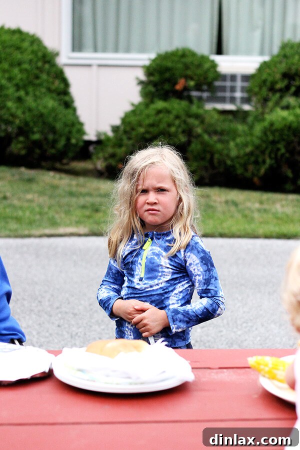 Ella at dinner Ella smiling brightly, clearly enjoying her meal during our relaxing Lake George vacation.