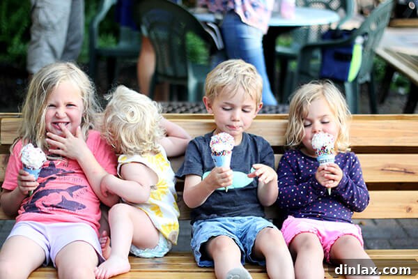 Family mealtime joy Four happy children gathered around, sharing laughter and good food during their memorable Lake George vacation.