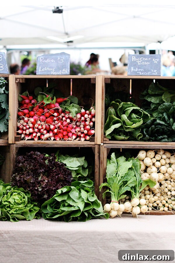 Bolton Landing Farmer's Market A bustling scene at the Bolton Landing Farmer's Market, showcasing a variety of local vendors and fresh goods under a tent.