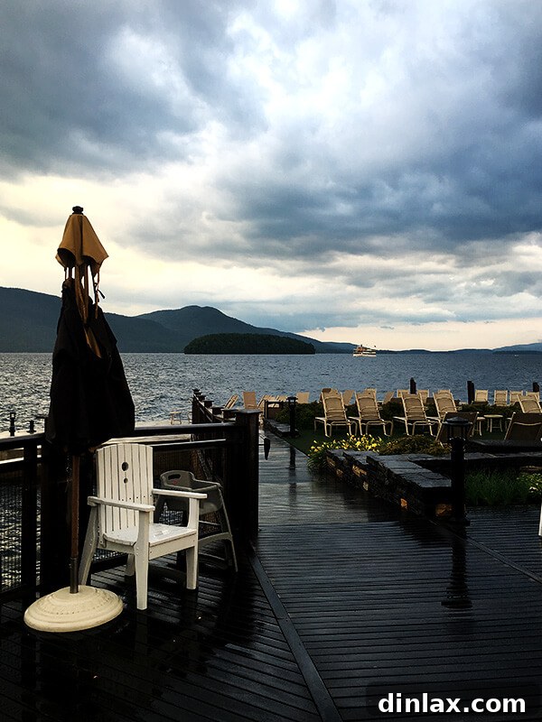 The Queen of American Lakes 16 The majestic Sagamore Resort on a stormy, dramatic evening, showcasing its iconic architecture against the moody Lake George sky.
